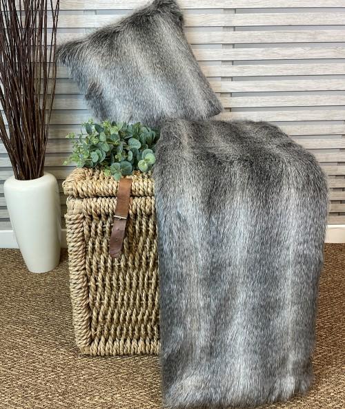 Grey striped faux fur throw with faux fur cushion