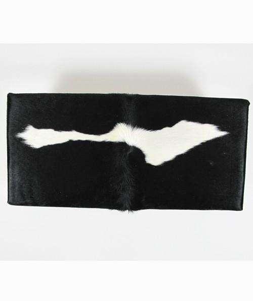 Striking modern cow hide footstool in black with a white streak 309