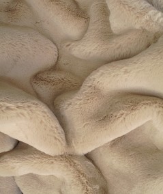 Close up image of the luxury beige faux fur throw